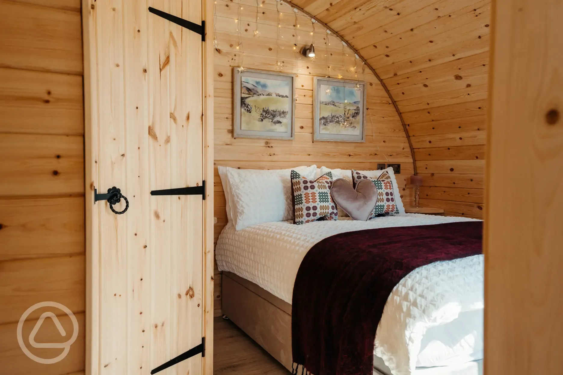 Luxury ensuite glamping pod bedroom with a double bed