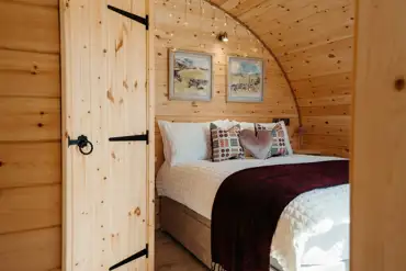Luxury ensuite glamping pod bedroom with a double bed