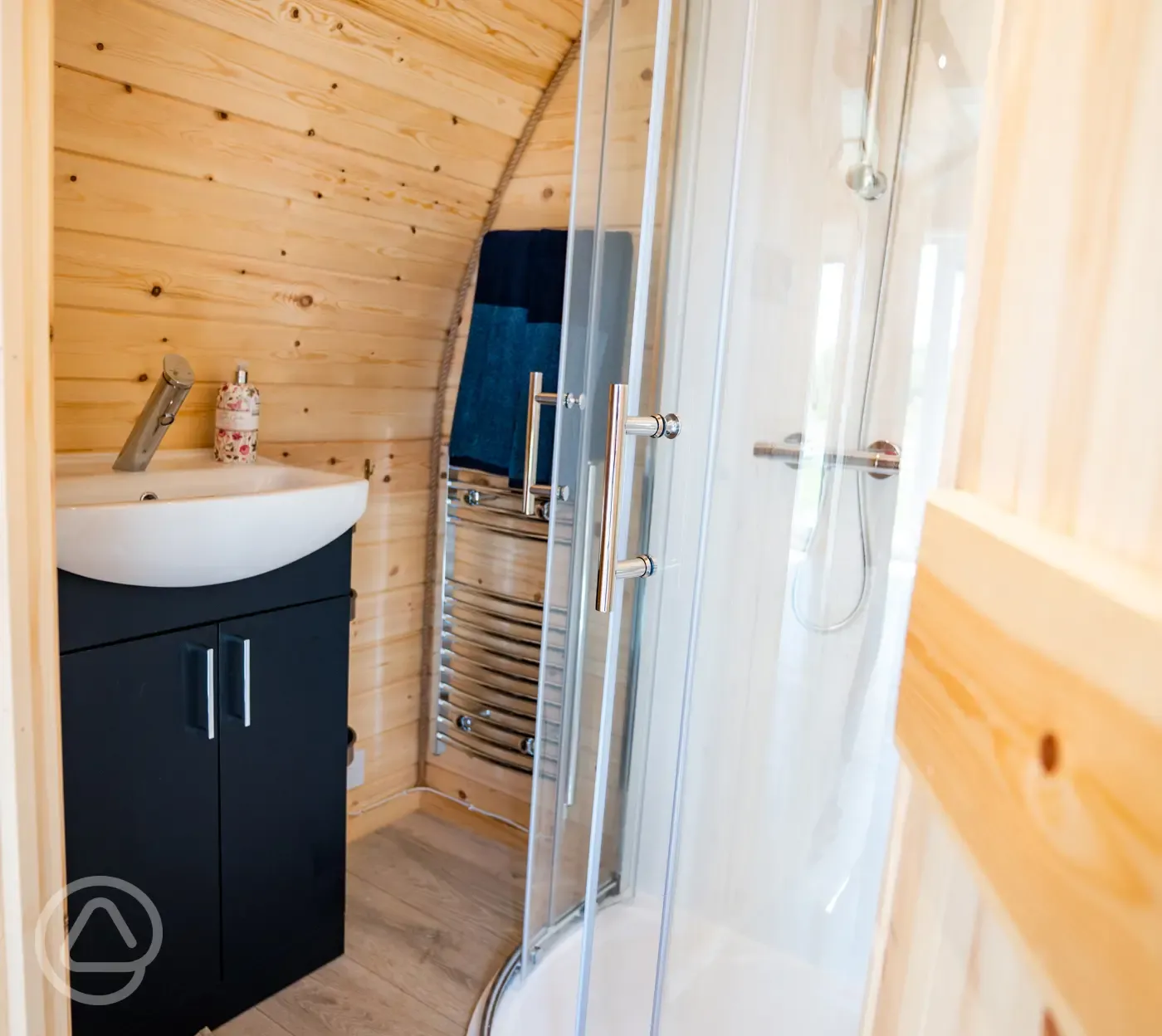 Luxury ensuite glamping pod ensuite with shower, heated towel rail and sink