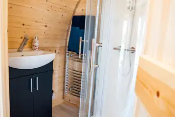 Luxury ensuite glamping pod ensuite with shower, heated towel rail and sink Luxury ensuite glamping pod ensuite with shower, heated towel rail and sink