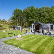 Luxury ensuite glamping pods exterior with private patio with fire pit