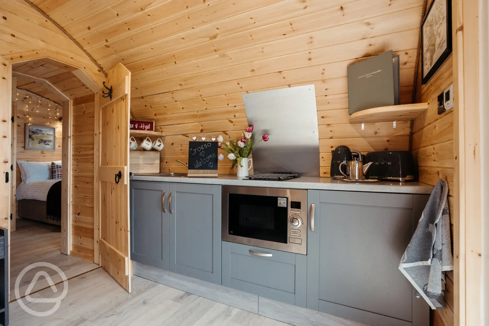 Luxury ensuite glamping pod kitchen with combi microwave, hob and fridge freezer