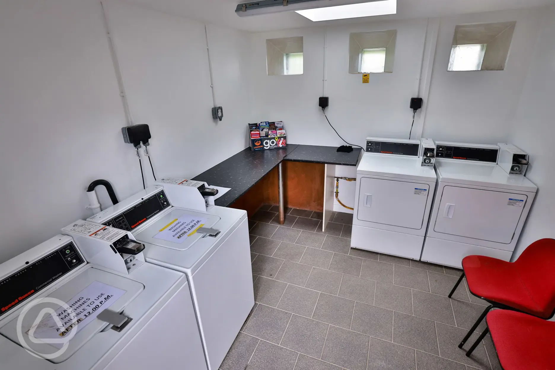 Laundry room with coin operated washing machines and dryers