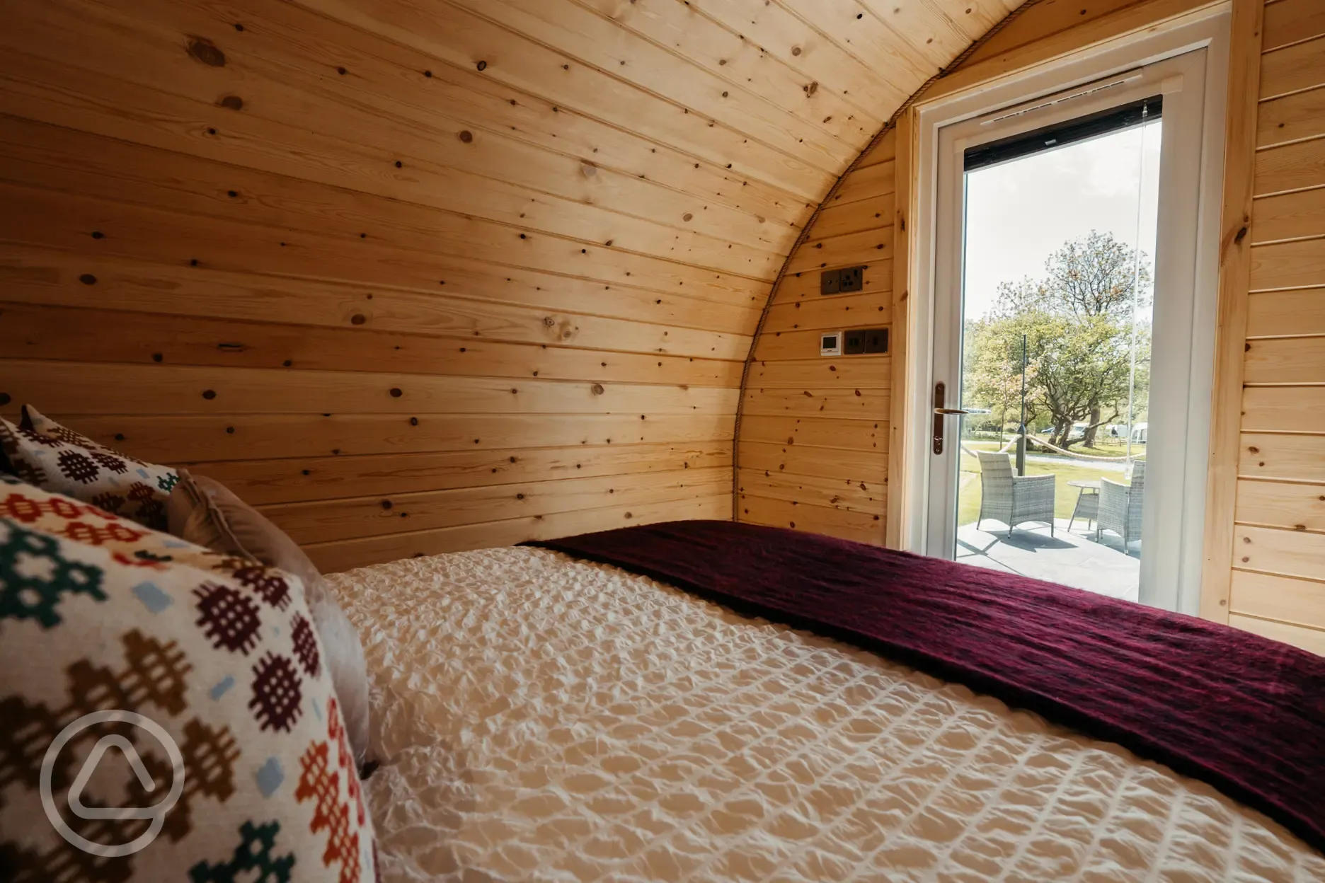Luxury ensuite glamping pod bedroom with outdoor views