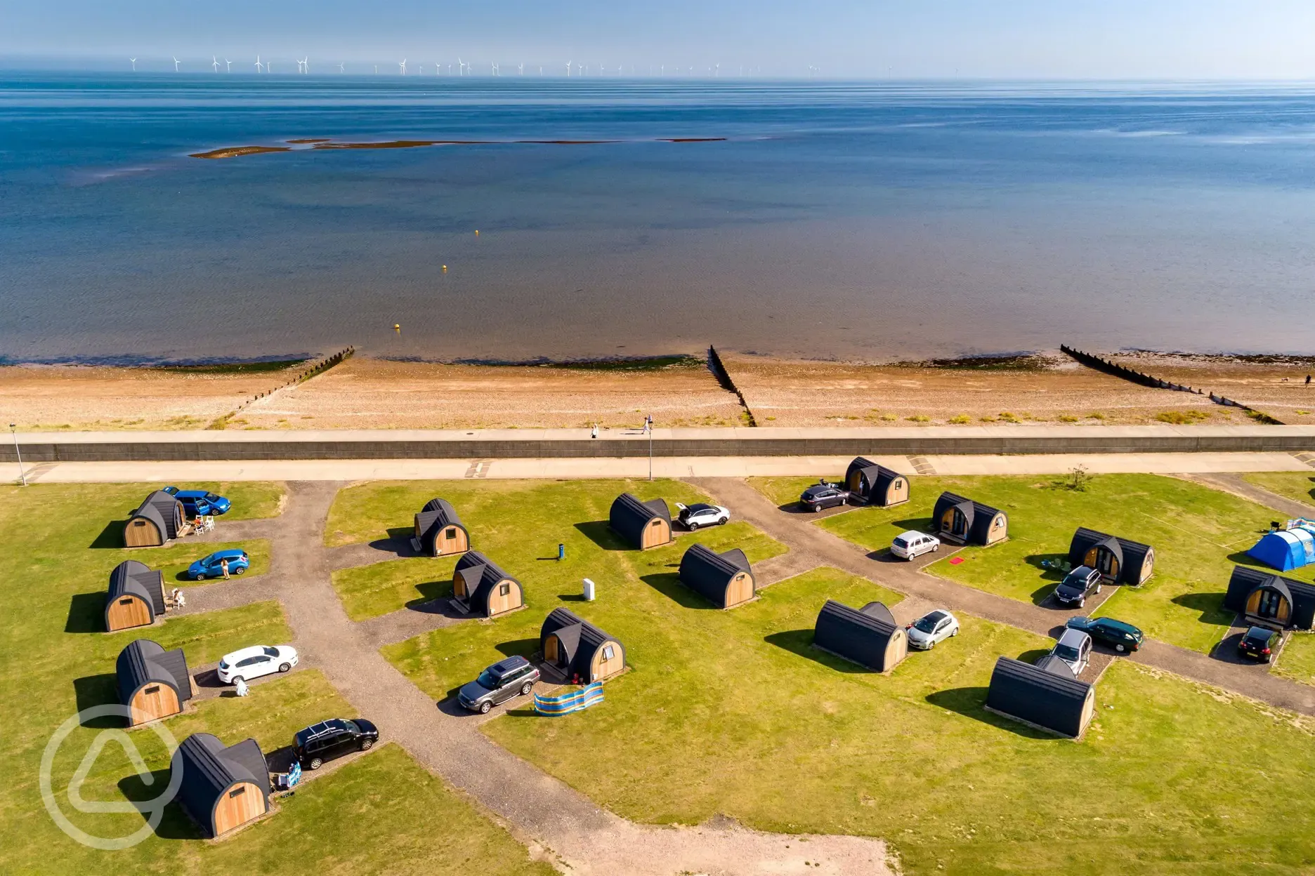 Aerial of camping pods with sea views