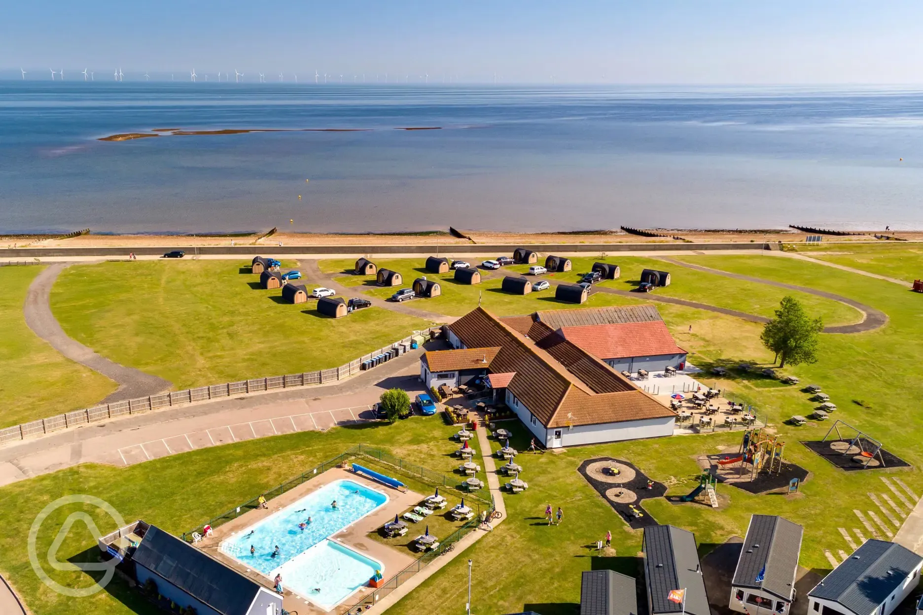 Aerial of the camping pods and coast