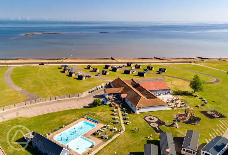 Aerial of the camping pods and coast