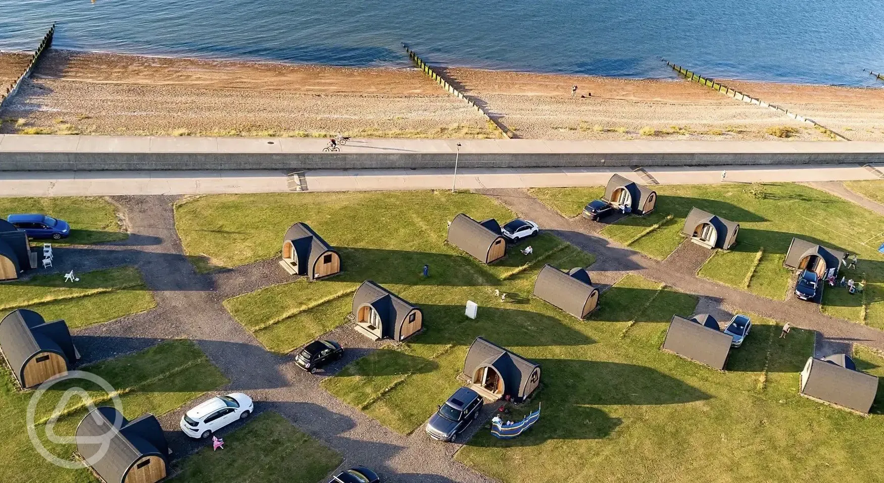Aerial of camping pods with sea views