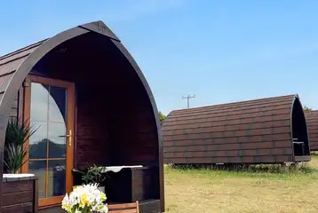 Glamping pods exterior with outdoor seating