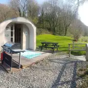 Camping pods (dog friendly) exterior with outdoor picnic benches and BBQs