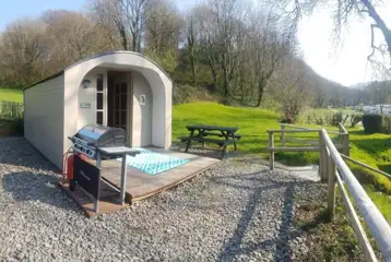 Camping pods (dog friendly) exterior with outdoor picnic benches and BBQs Camping pods (dog friendly) exterior with outdoor picnic benches and BBQs