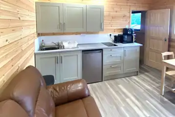 Silver Birch lodge lounge/kitchen area with a fridge, air fryer, and seating