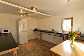 Hill View huts - seven person kitchen featuring a fridge/freezer, microwave etc