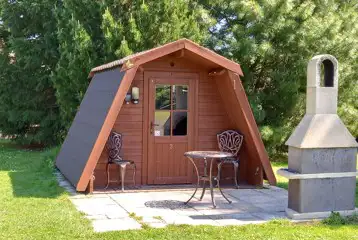 Camping pod with furniture and a chimnea