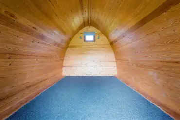 Camping pod interior with space for air beds and camp beds