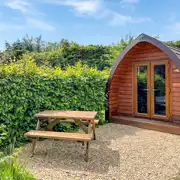 Camping pod exterior with private outdoor dining area Camping pod exterior with private outdoor dining area