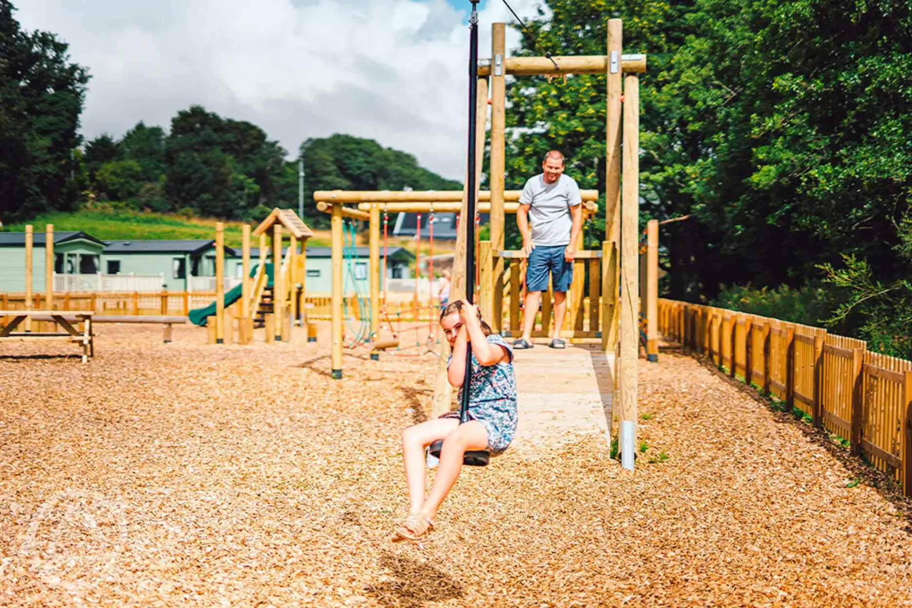 Outdoor play area with a zip line