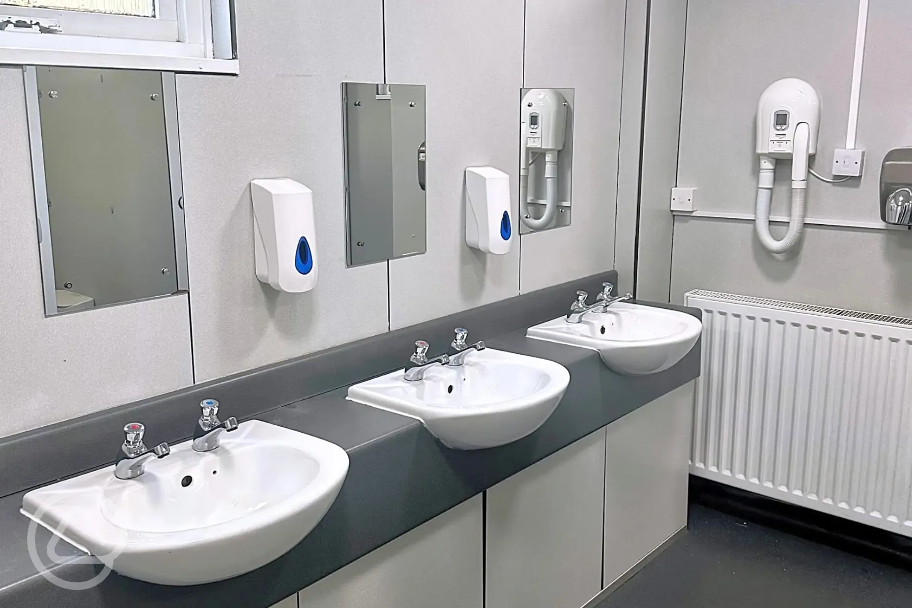 Bathrooms with hand basins, mirrors, hairdryers and hand dryers