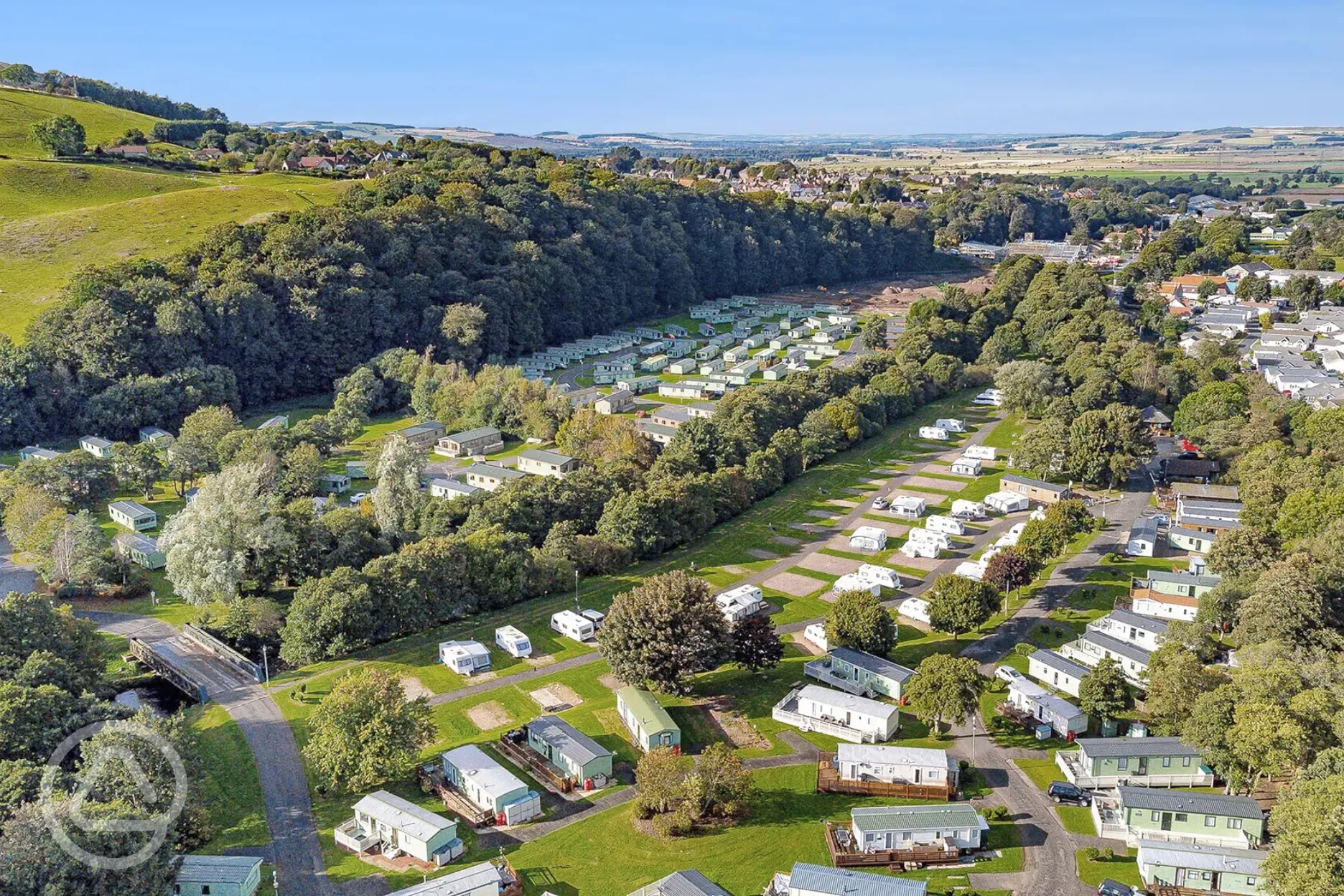 Aerial of Riverside Wooler Holiday Park with hardstanding pitches