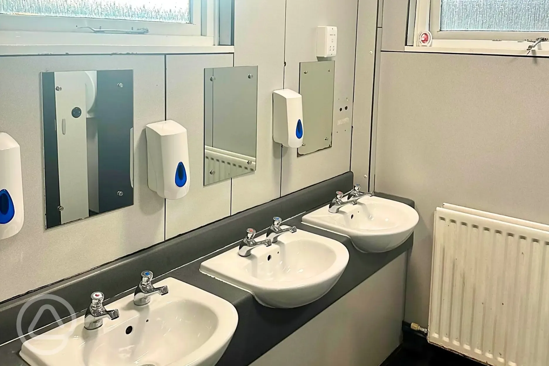 Bathrooms with hand basins, mirrors, hairdryers and hand dryers