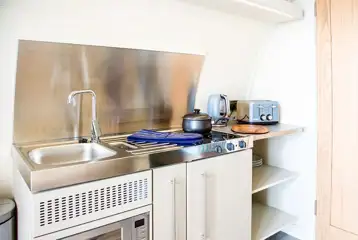 Superior pod kitchen with a microwave, hob, fridge/freezer, kettle and toaster