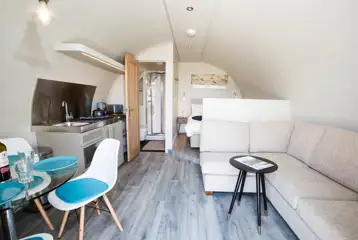 Superior pod with a double bed, double sofa bed, kitchen and dining area