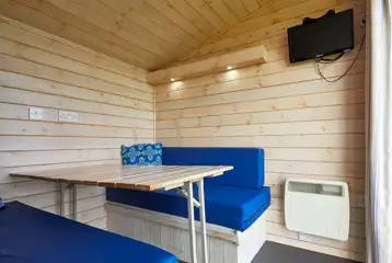 Standard beach hut dining area and TV (bring own crockery and utensils)