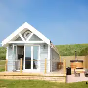 Deluxe ensuite beach hut with a wood-fired hot tub, fire pit and seating Deluxe ensuite beach hut with a wood-fired hot tub, fire pit and seating