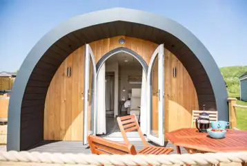 Superior ensuite glamping pod with outdoor seating and glass doors