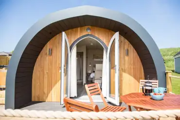 Superior ensuite glamping pod with outdoor seating and glass doors