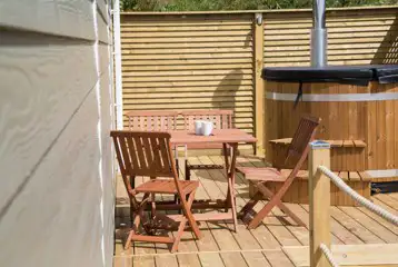Deluxe beach hut outdoor seating and wood-fired hot tub