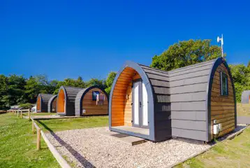 Camping pods with small gravel patio areas Camping pods with small gravel patio areas