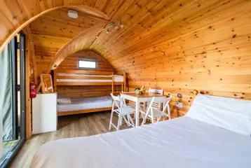 Camping pod interior with electric, a table, chairs and radiator Camping pod interior with electric, a table, chairs and radiator