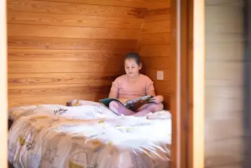 Family Vista camping pod interior with a double bed, bunk beds and trundle bed Family Vista camping pod interior with a double bed, bunk beds and trundle bed