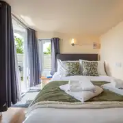 Garden View cabin interior with a 4ft 6"double bed with bedding