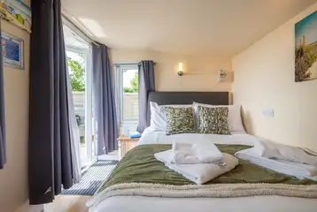 Garden View cabin interior with a 4ft 6"double bed with bedding Garden View cabin interior with a 4ft 6"double bed with bedding