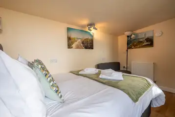 Garden View cabin interior with a 4ft 6"double bed with bedding Garden View cabin interior with a 4ft 6"double bed with bedding