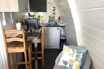 Ensuite glamping pod kitchen with a small seating area Ensuite glamping pod kitchen with a small seating area