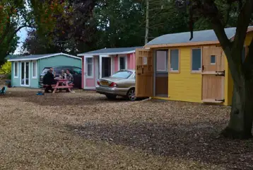 Beach hut cabins with parking spaces and picnic benches Beach hut cabins with parking spaces and picnic benches