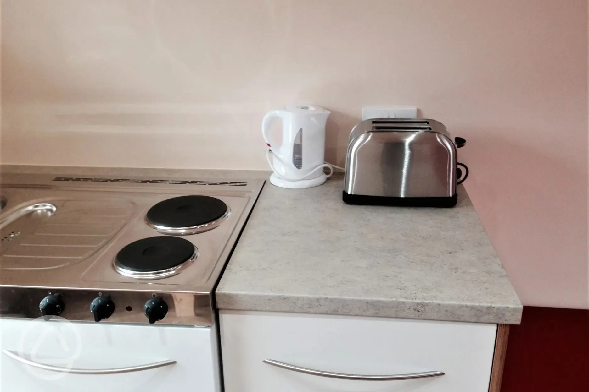 Camping pod kitchen with fridge, water carrier, electric hob, toaster and kettle