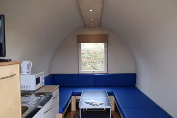Camping pod interior with mattresses, folding table, lighting and heating Camping pod interior with mattresses, folding table, lighting and heating
