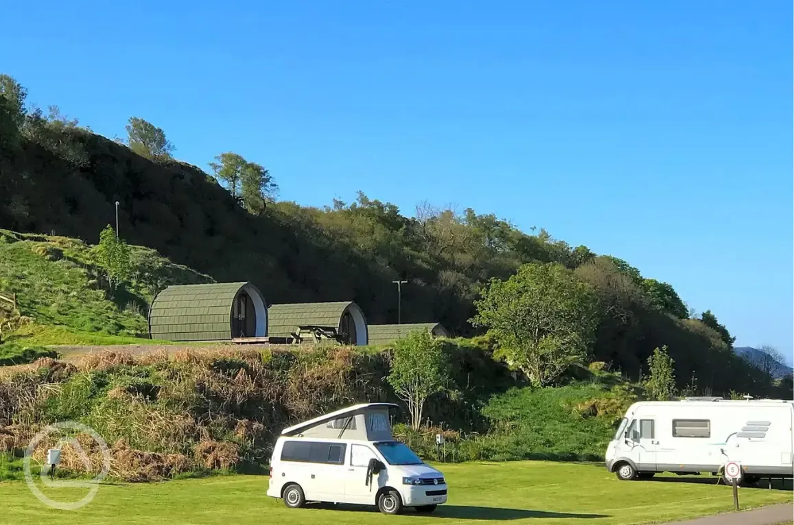 Electric grass pitches with 16 amp electric hook ups with camping pods behind