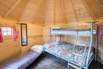 Camping cabin bunk bed and fold-out camp bed (bedding not provided)