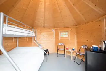 Camping cabin triple sleeper bunk bed and dining space