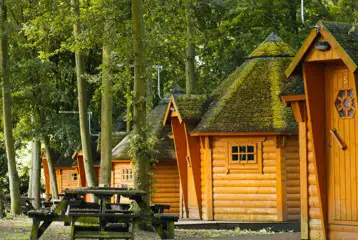 Camping cabins exterior with picnic benches