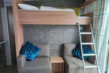 S pod (four person) interior with a double sofa bed and a bunk bed