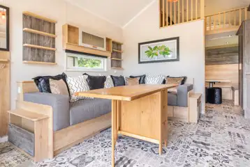 Jurassic Escape Pod lounge with a sofa, table, and soft furnishings Jurassic Escape Pod lounge with a sofa, table, and soft furnishings