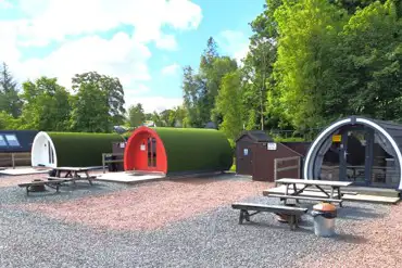 Deluxe glamping pods with hot tubs and privacy fencing