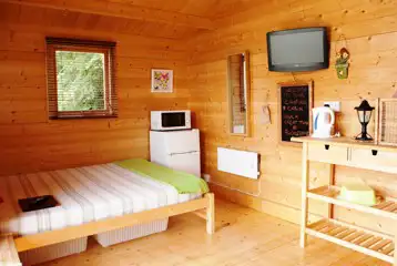 Camping cabin with a king size bed, TV, fridge, kettle and microwave Camping cabin with a king size bed, TV, fridge, kettle and microwave