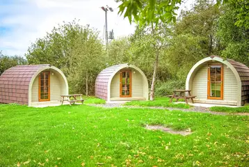 View of the camping pods with a picnic table
